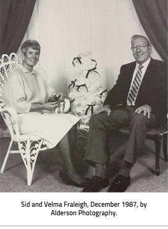 (Sid and Velma sit in front of a small Christmas Tree. Image Caption:": Sid and Velma Fraleigh, December 1987, by Alderson Photography."), link.