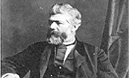 Black and white image of a man sitting.