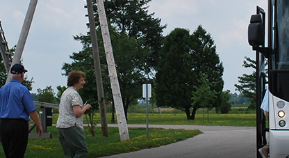 Two people walking towards a bus.