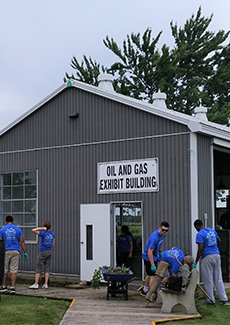 Volunteers outside the oil and gas exhibit building at OMC.