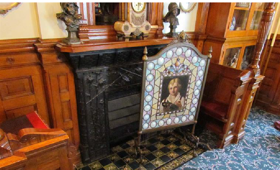 Old fireplace with ornate stained glass.