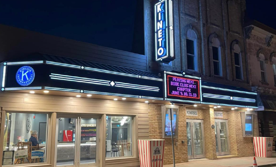 Yellow brick building at night with led lighting and signage