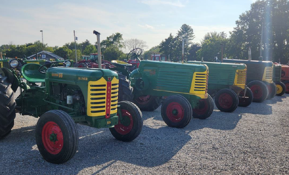 Row of antique green tractors.