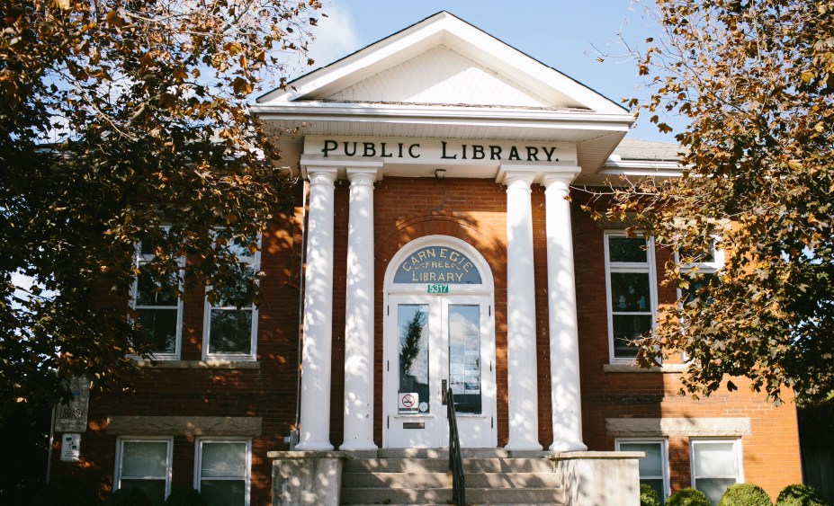 Red brick building with white columns.