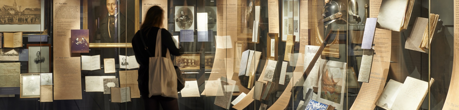 lady looking at a museum display of old artifacts